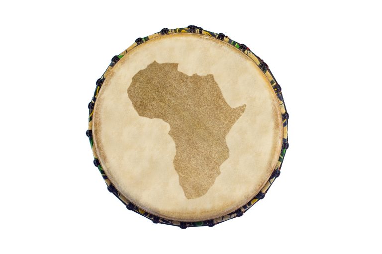 top view of an african traditional djembe with africa continent silhouette on white background